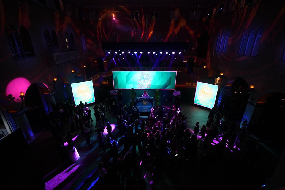Publicis 100-year celebration — evening stage with three LED surfaces and live lighting